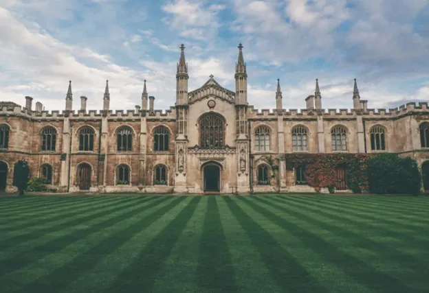 Historic gothic university courtyard with striped lawn